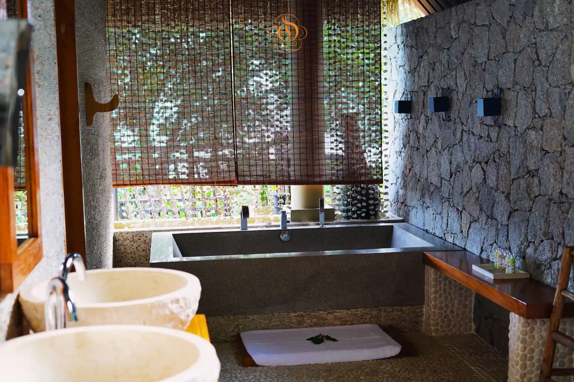 bathroom sinks in a presidential villa at Le Domaine de L’Orangeraie Resort & Spa with modern fixtures and tropical inspired design