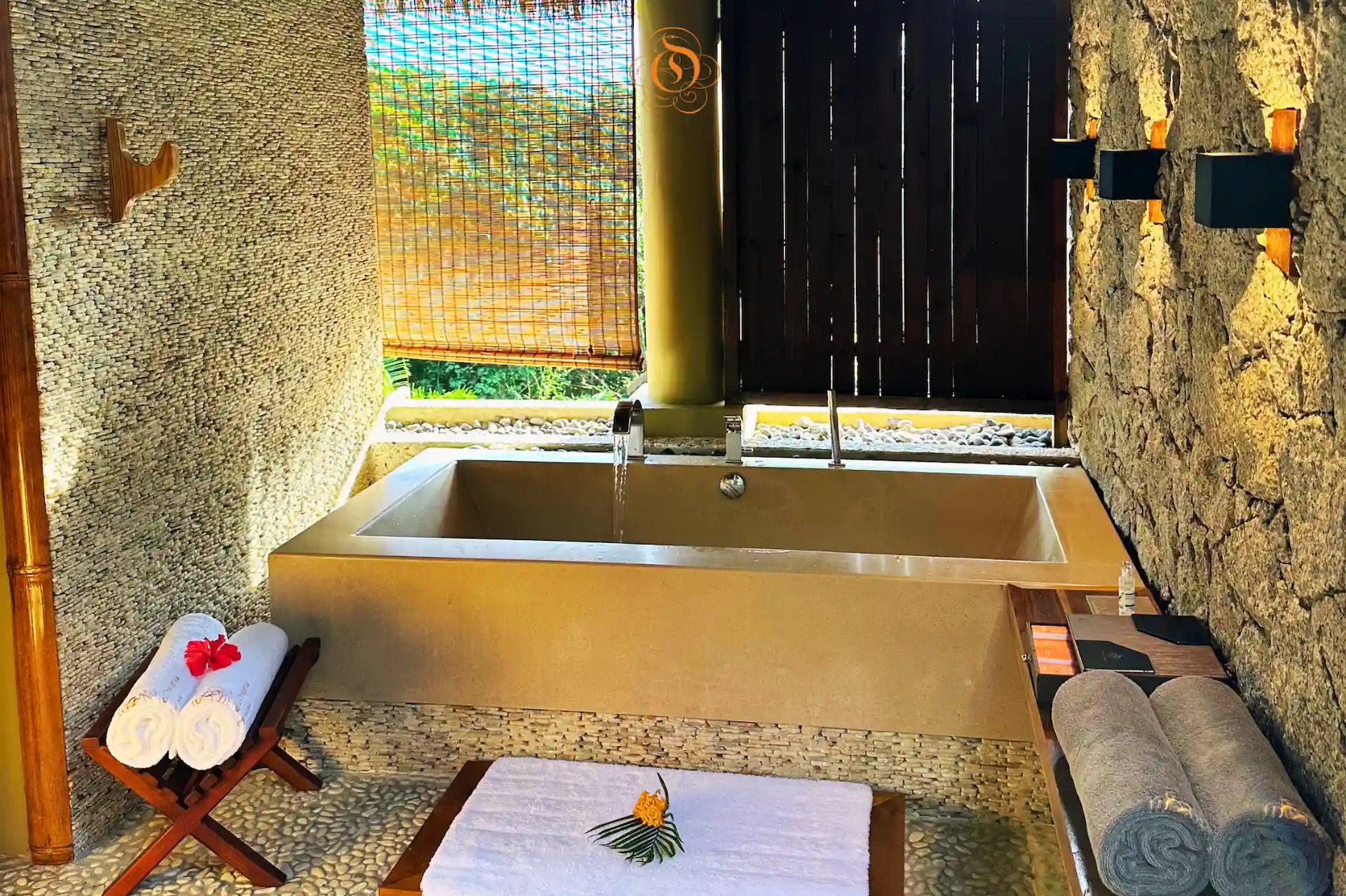 bath area in a villa de charme at Le Domaine de L’Orangeraie Resort & Spa with an elegant bathtub and tropical inspired setting