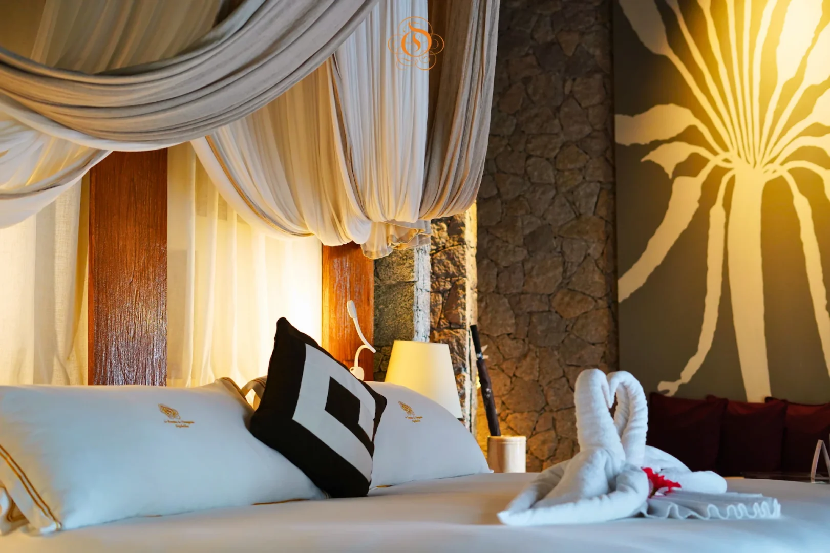 bed in a villa de charme at Le Domaine de L’Orangeraie Resort & Spa with a large bed and elegant tropical style decor