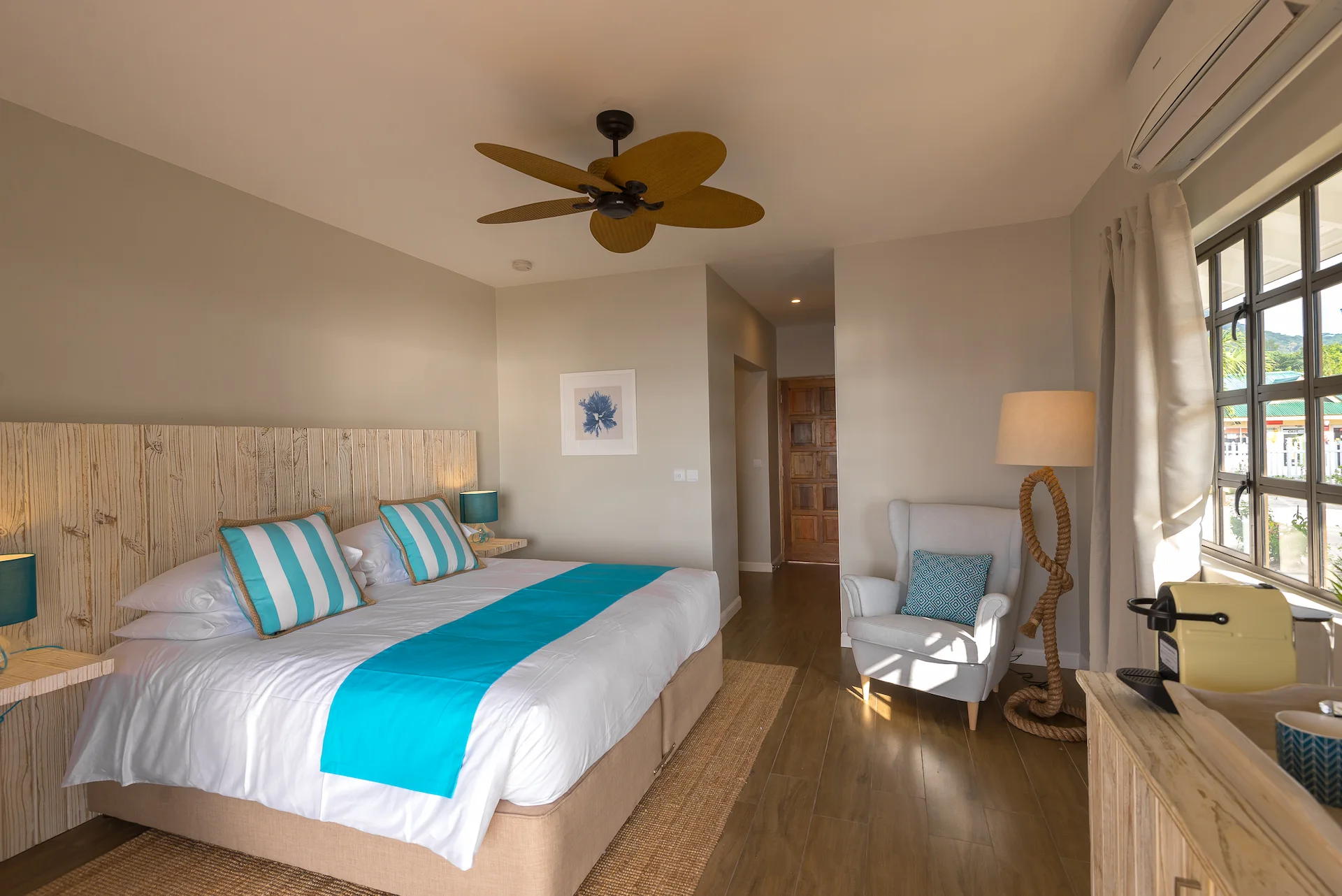 bedroom at Le Nautique with a comfortable bed and simple tropical inspired decor