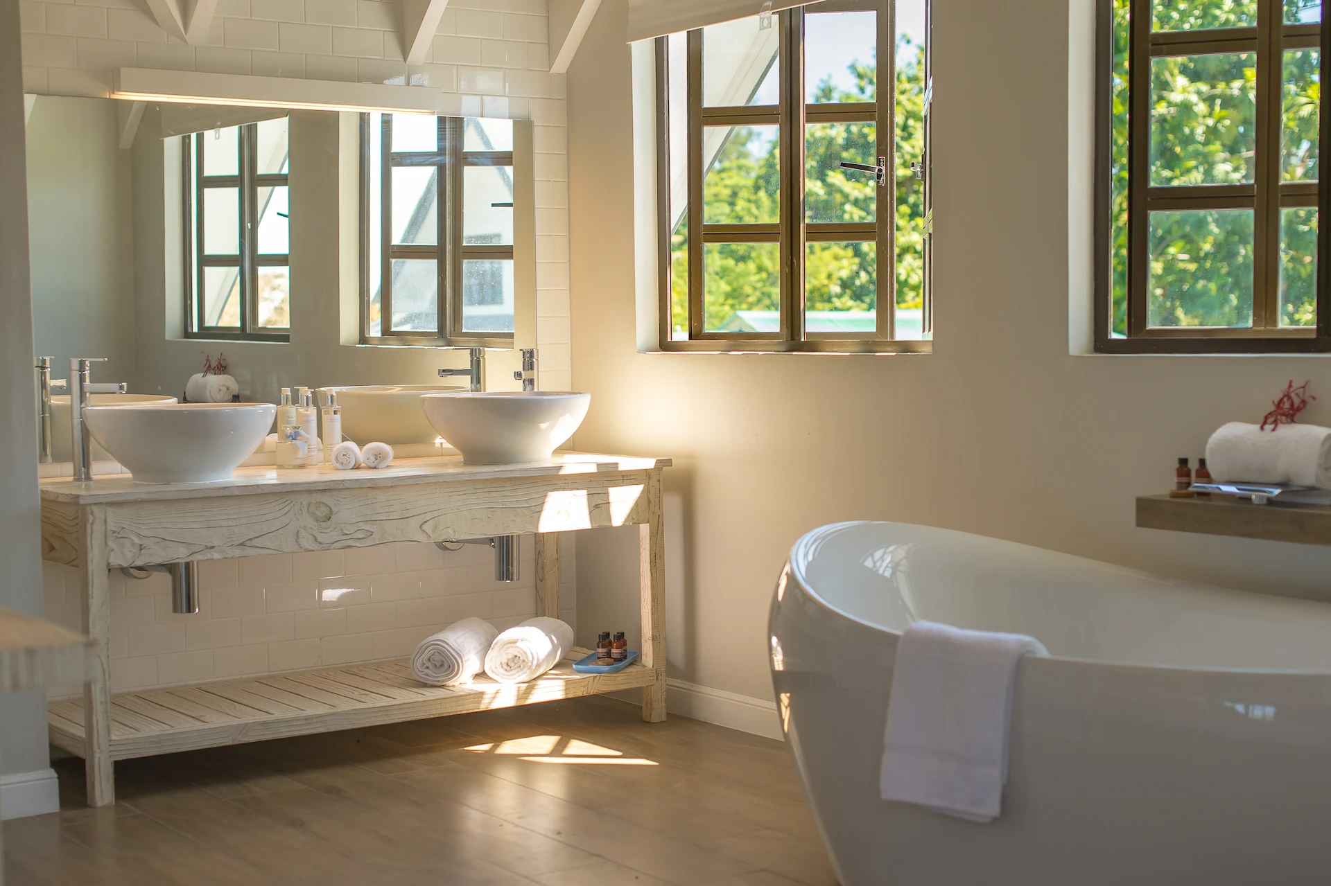 bed in a king deluxe seafront room at Le Nautique with a large bed and natural light from ocean facing windows