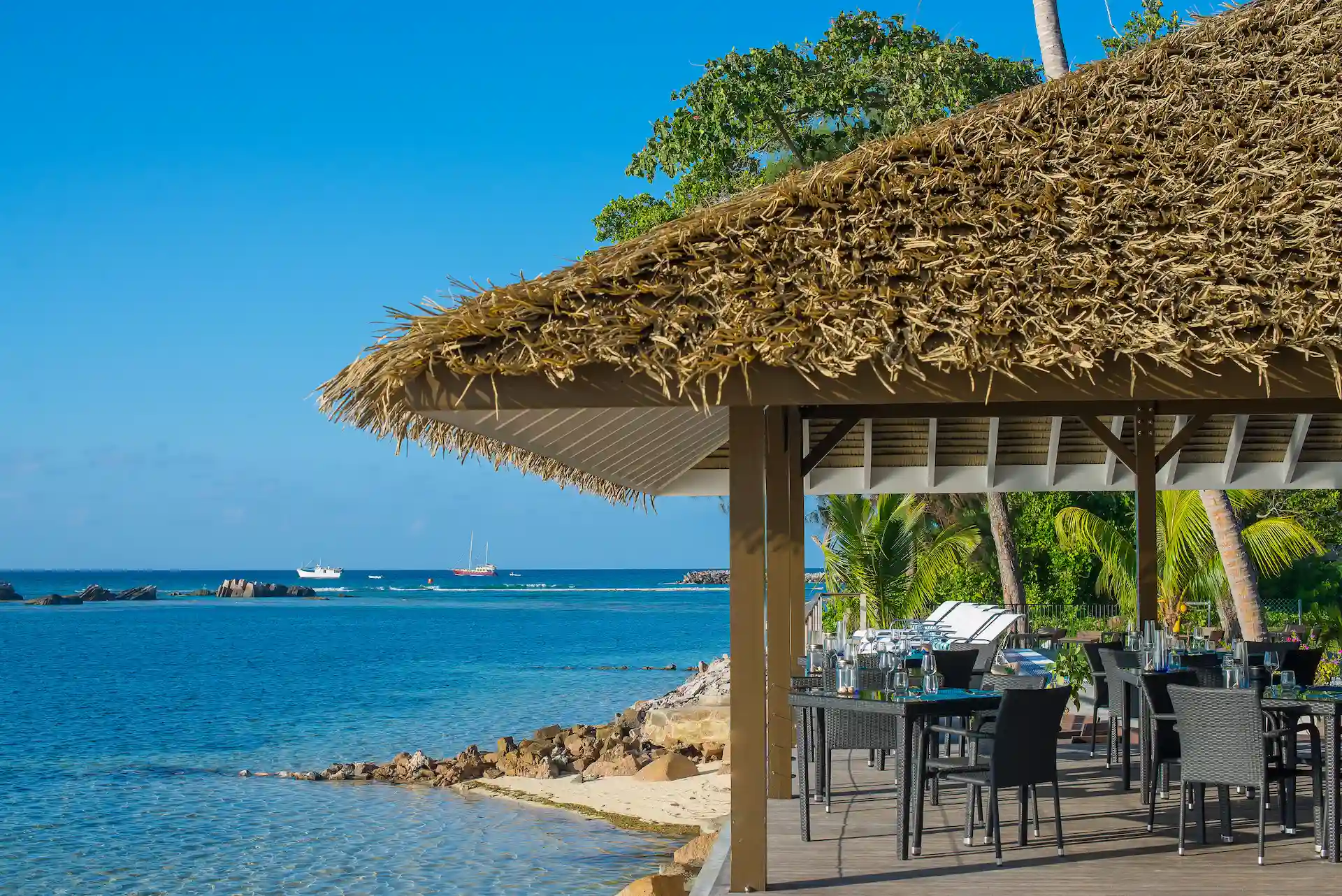 restaurant at Le Nautique with indoor and outdoor seating in a relaxed beachfront setting overlooking the ocean