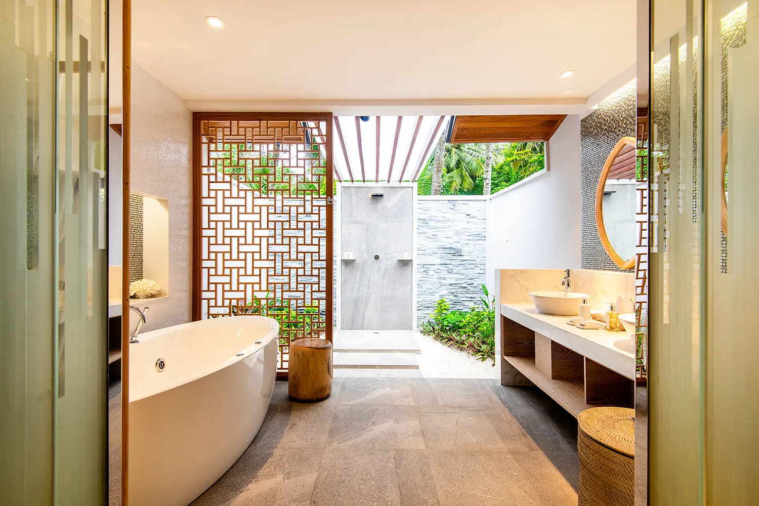 lily beach maldives beach suite semi open bathroom featuring elegant tropical design soft natural light and a serene airy ambience