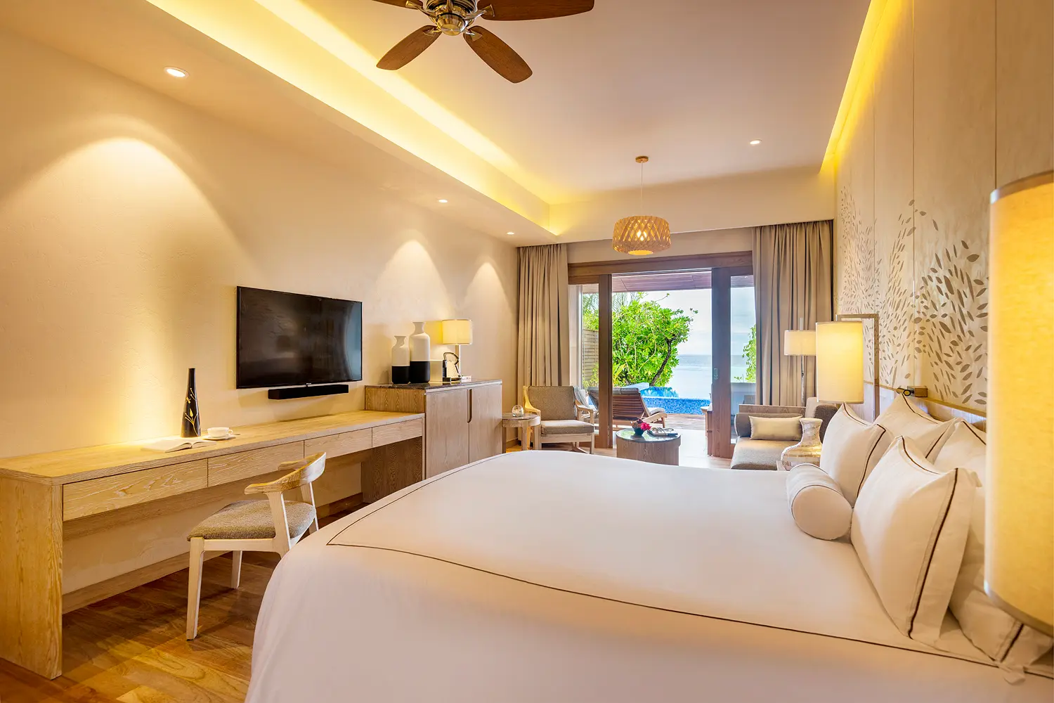 lily beach maldives beach suite with pool bedroom with view overlooking the shoreline with soft natural light and serene tropical ocean ambience