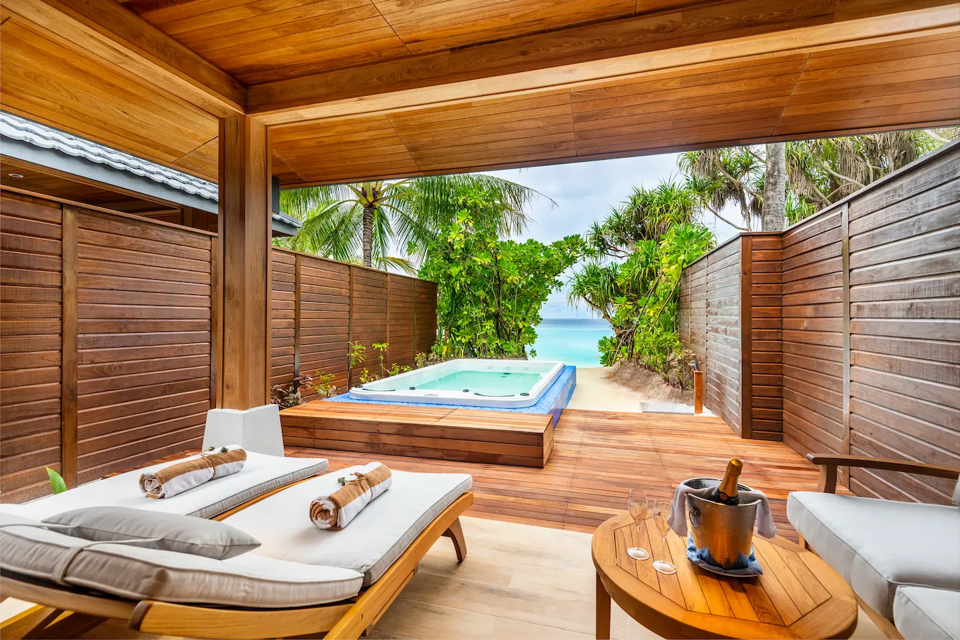 lily beach maldives beach suite with pool jacuzzi deck overlooking the shoreline with elegant open air tropical design and serene private poolside ambience