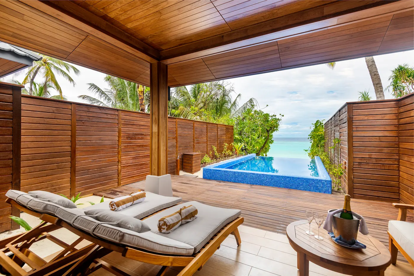 lily beach maldives beach suite with pool pool terrace overlooking the shoreline with elegant open air seating serene tropical ambience and private poolside views