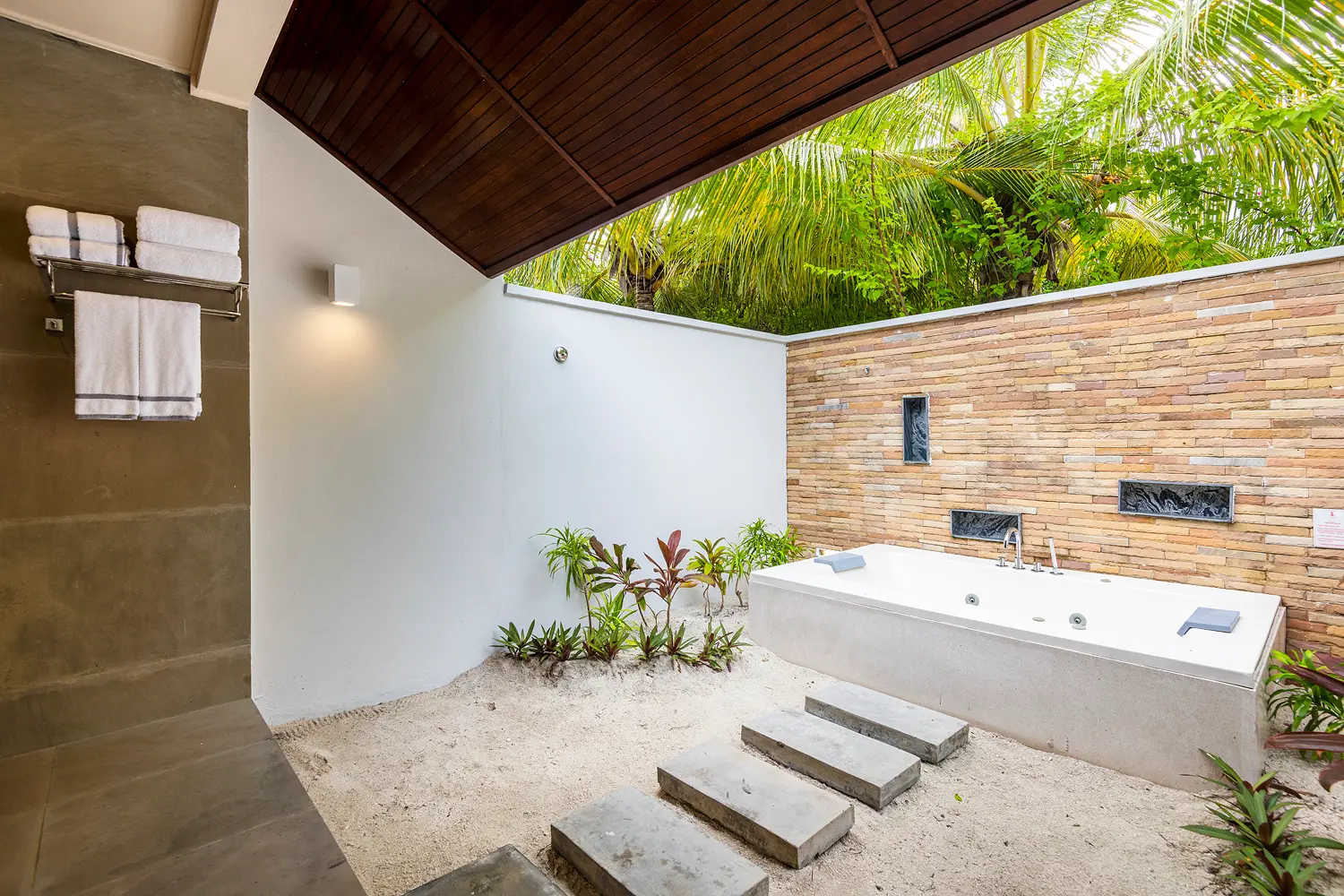 lily beach maldives beach villa bathtub with serene tropical ambience featuring elegant design and soft natural light