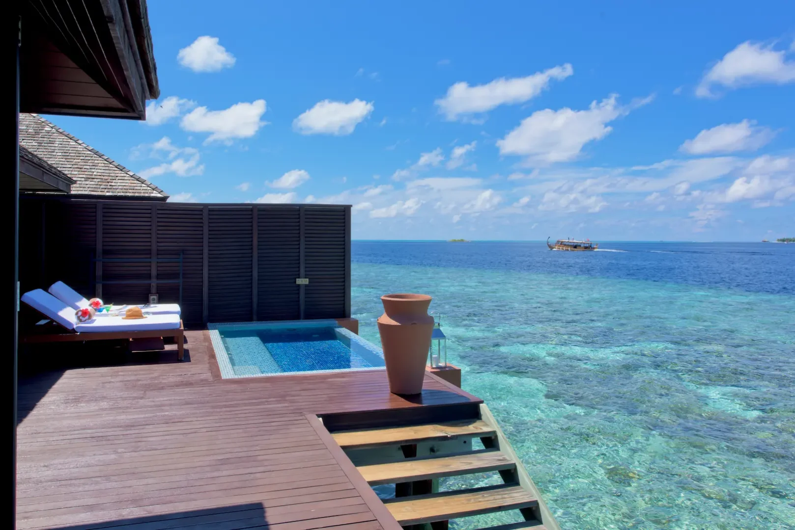 lily beach maldives deluxe water villa ocean access with steps leading directly into the turquoise lagoon and serene tropical views