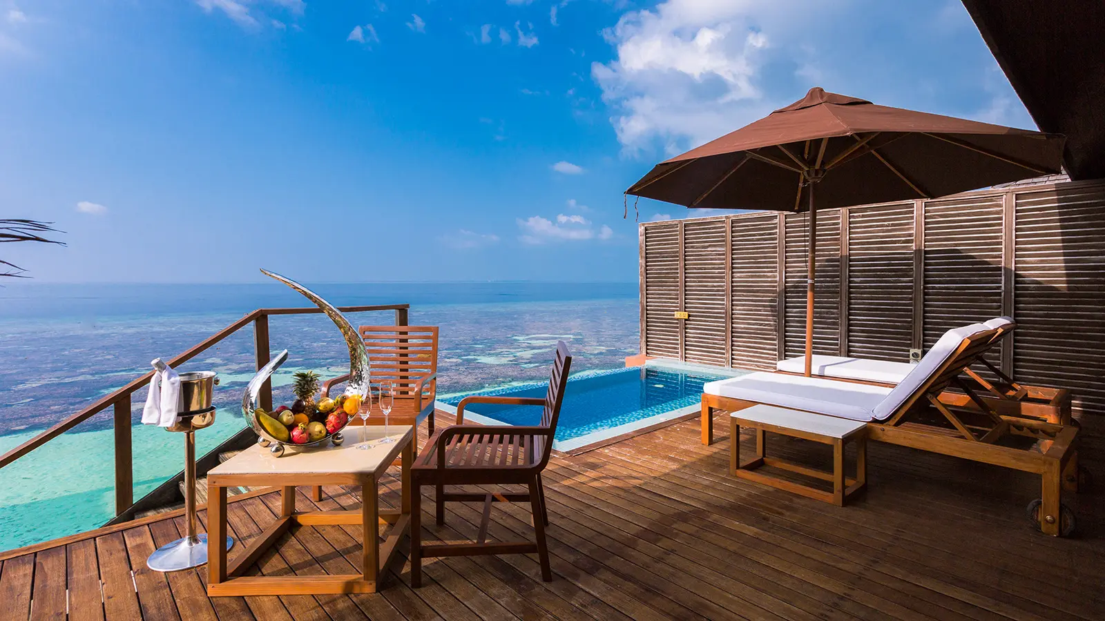 lily beach maldives deluxe water villa plunge pool overlooking the calm lagoon with a private deck and serene luxury ambience