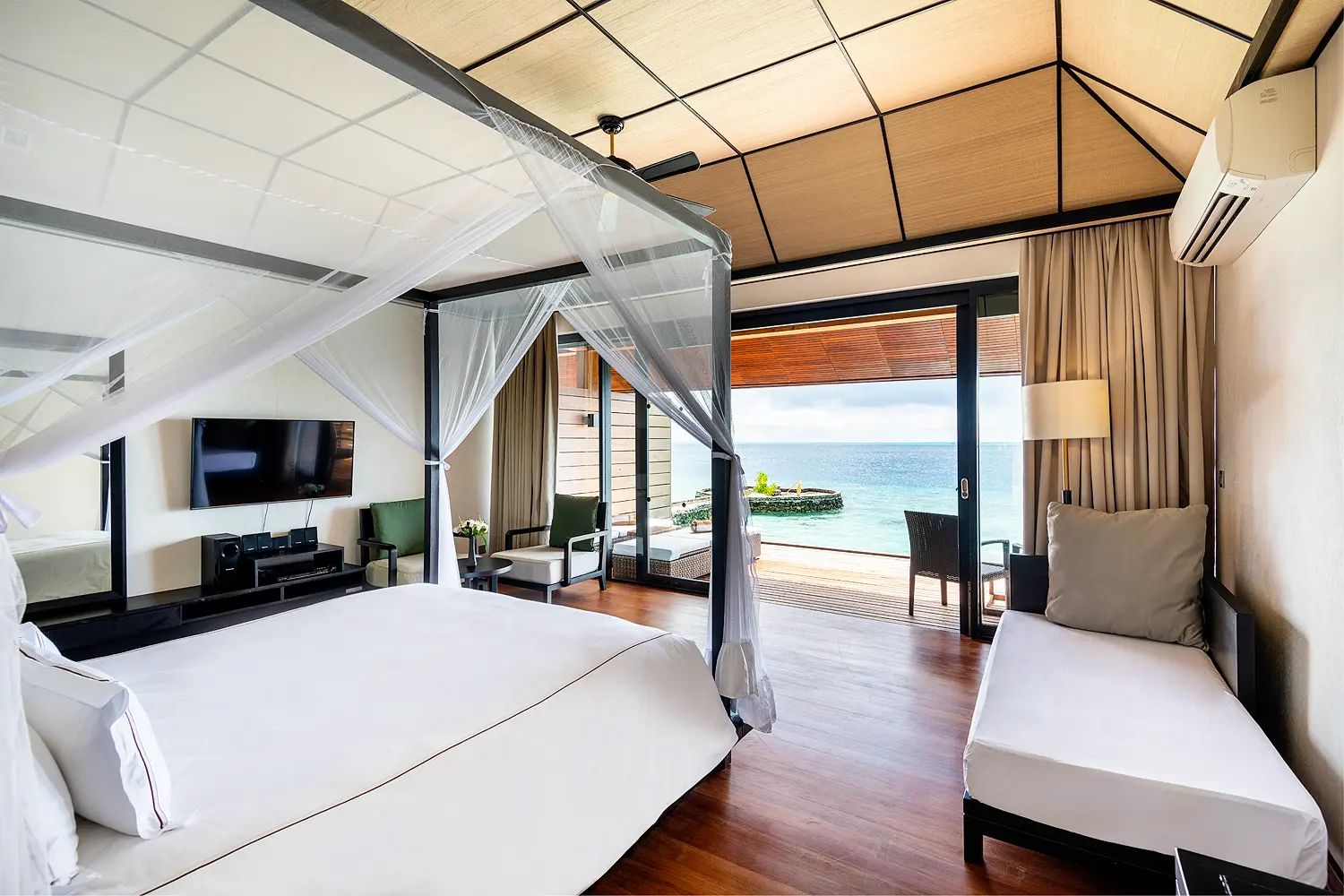 lily beach maldives lagoon villa bed with soft natural light and serene tropical ambience overlooking the tranquil lagoon