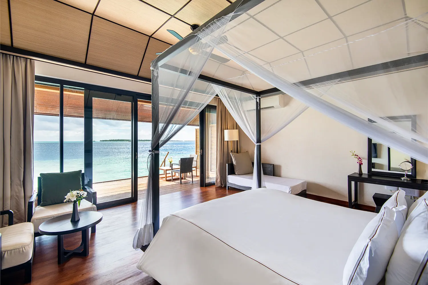 lily beach maldives lagoon villa bedroom featuring a serene tropical design with soft natural light and tranquil lagoon inspired ambience