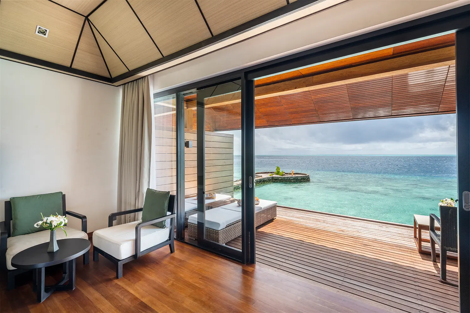 lily beach maldives lagoon villa terrace overlooking the tranquil lagoon with serene tropical ambience and elegant open air relaxation space