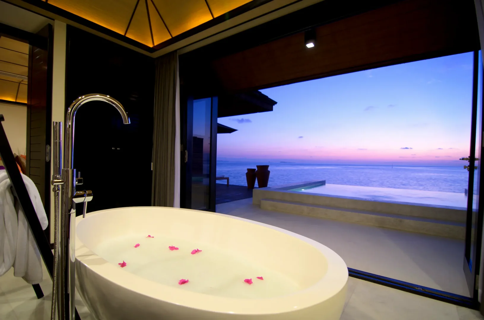 lily beach maldives sunset water suites bath with elegant modern design soft natural lighting and serene lagoon inspired ambience