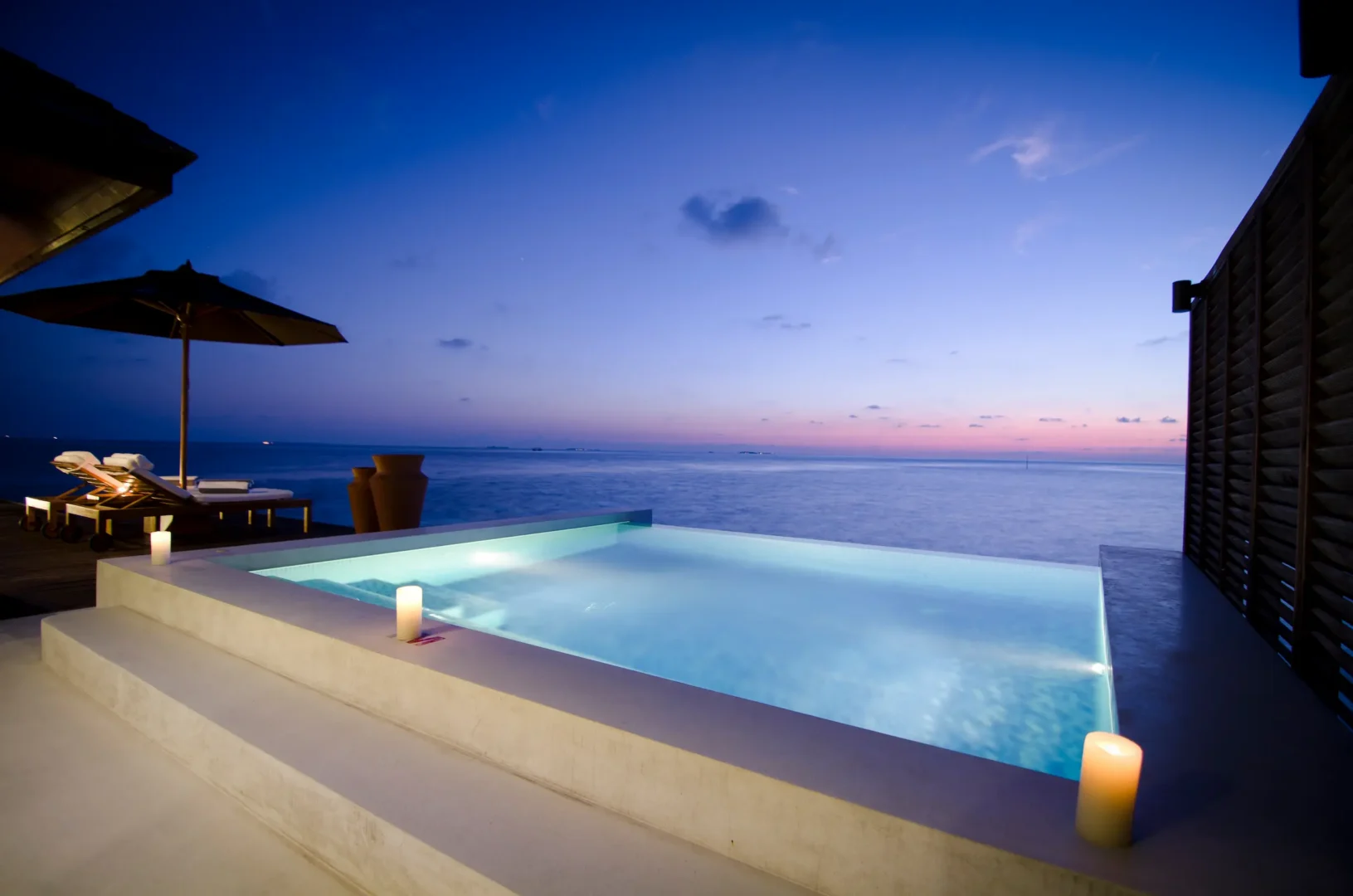 lily beach maldives sunset water suites plunge pool overlooking the tranquil lagoon with serene tropical ambience and elegant open air luxury