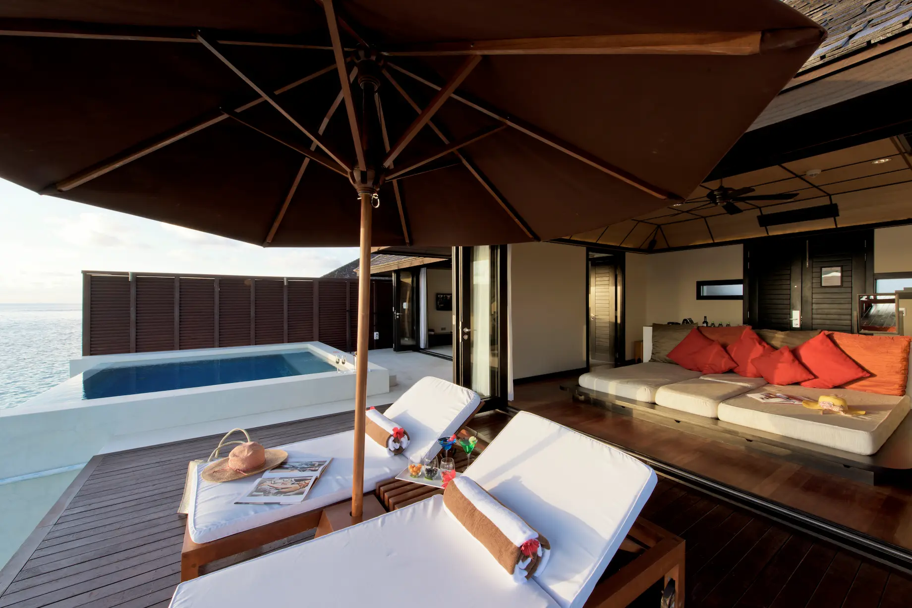 lily beach maldives sunset water suites sunbed set above the lagoon with serene sunset views and elegant open air tropical ambience