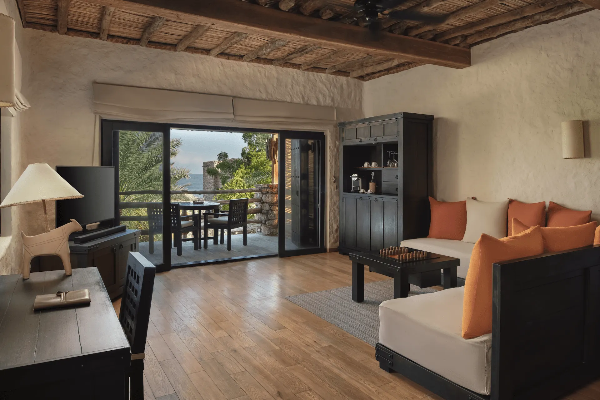 living room in duplex two bedroom pool villa at six senses zighy bay oman