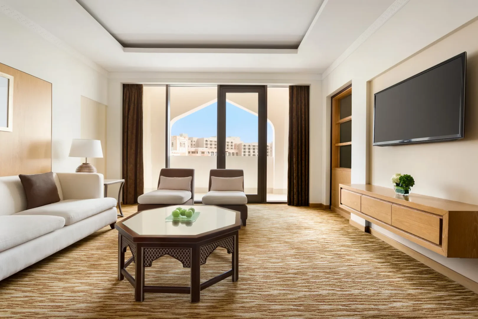 interior lounge area with table in one bedroom suite at hilton muscat al bandar oman resort