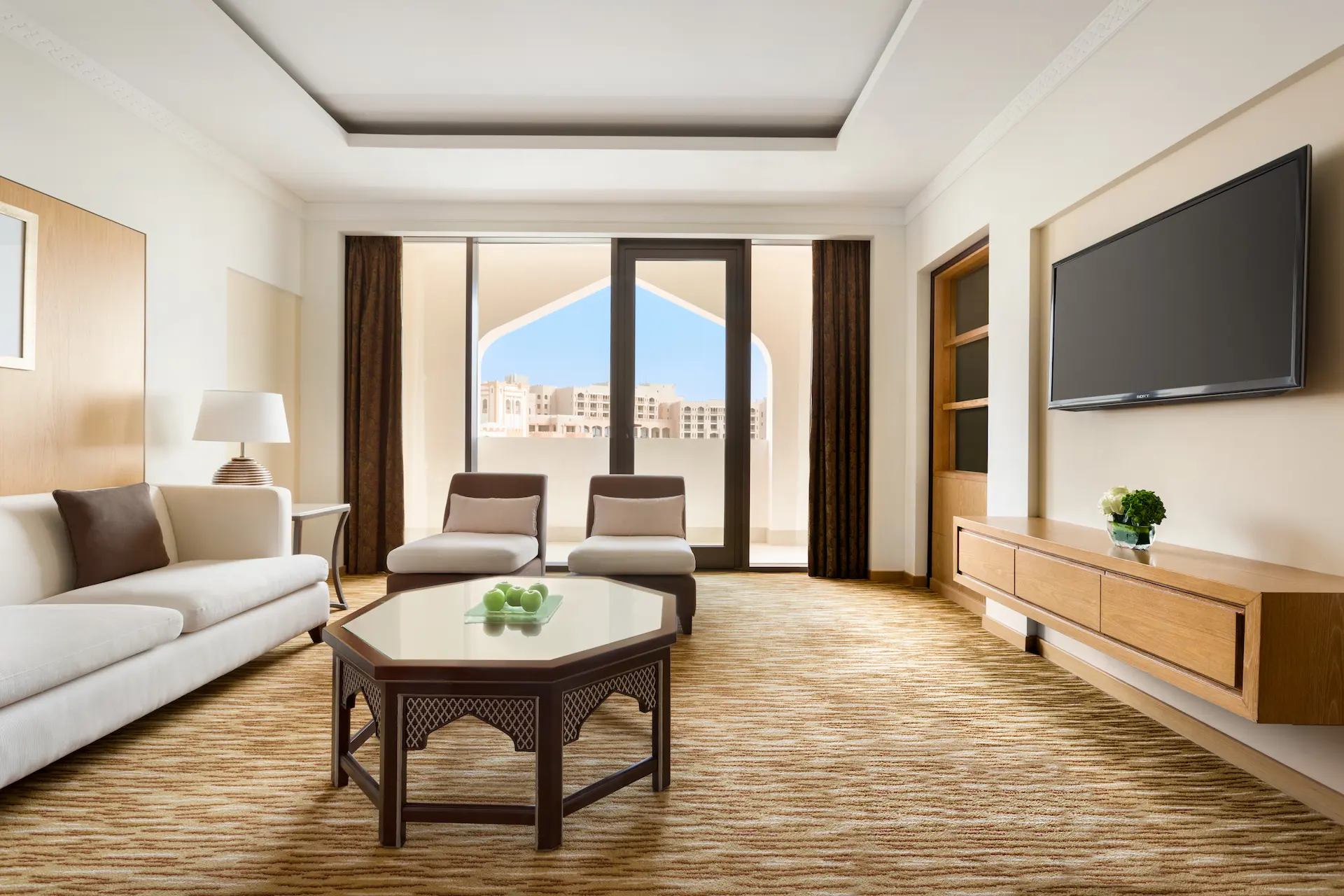 interior lounge area with table in one bedroom suite at hilton muscat al bandar oman resort