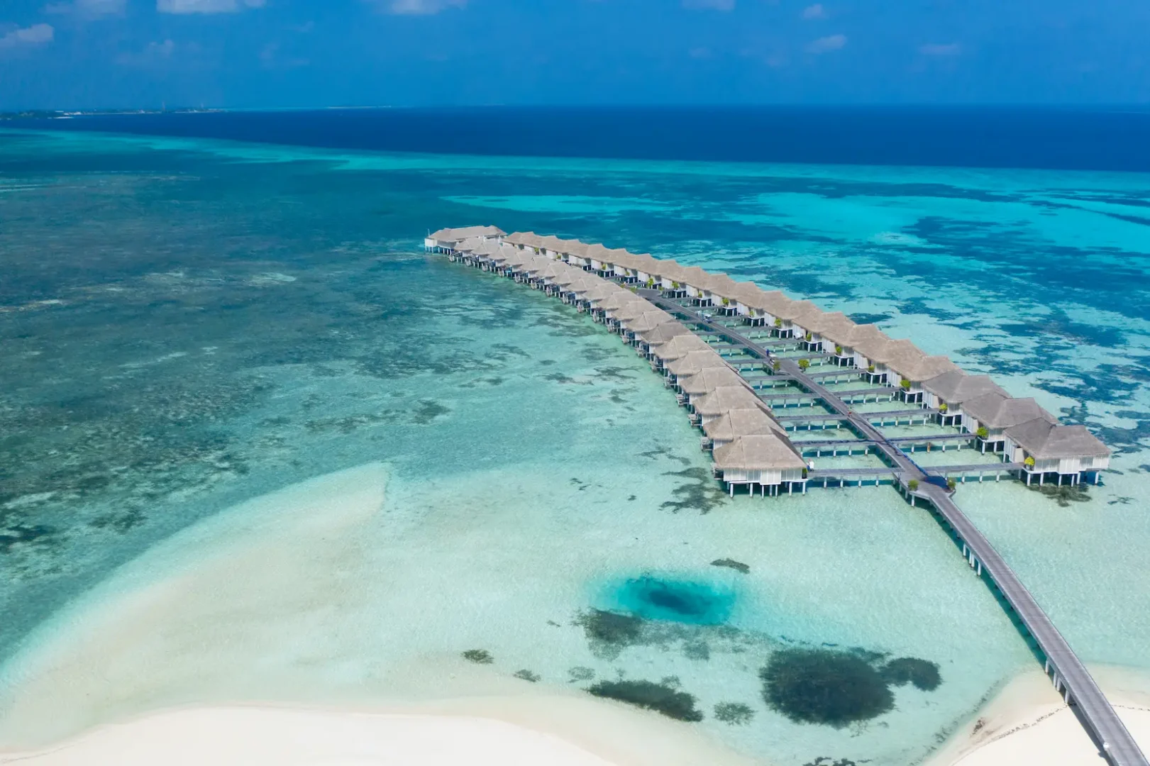 lux south ari atoll aerial water villas overlooking the turquoise lagoon