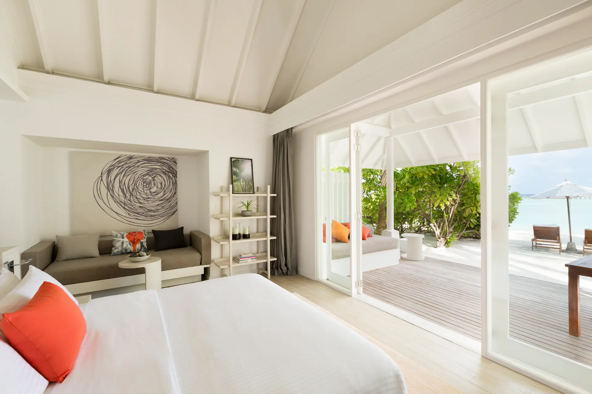 lux south ari atoll beach villa bedroom with serene island inspired interior design