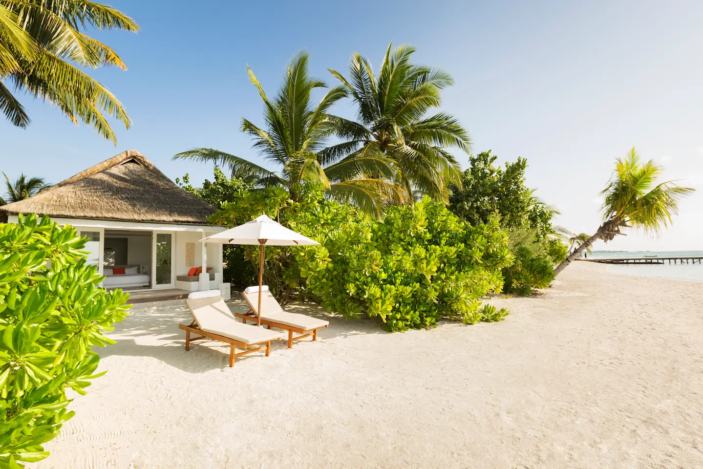 lux south ari atoll beach villa exterior with serene beachfront surroundings