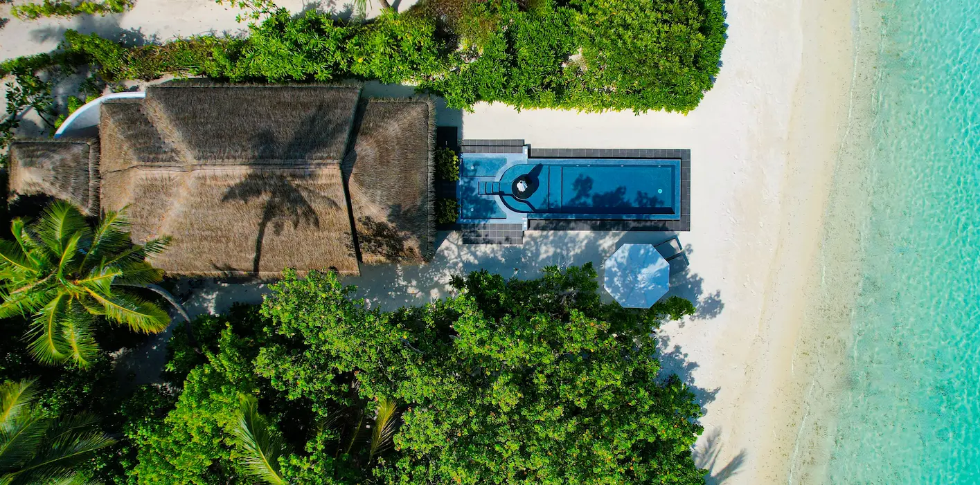 lux south ari atoll beachfront infinity pool villa aerial view over the turquoise lagoon