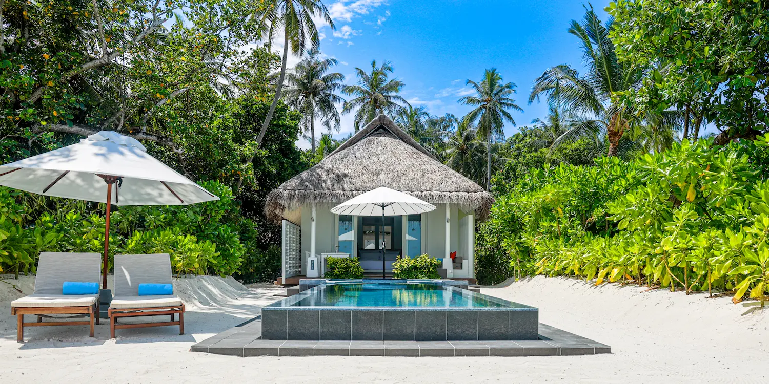 lux south ari atoll beachfront infinity pool villa exterior with serene tropical beachfront surroundings