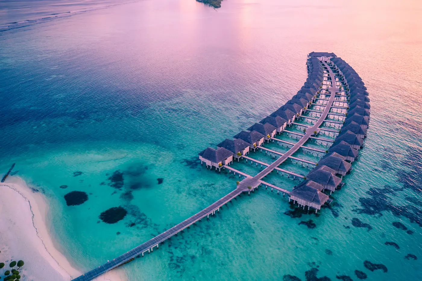 lux south ari atoll maldives aerial water villas view showcasing overwater villas stretching across the lagoon