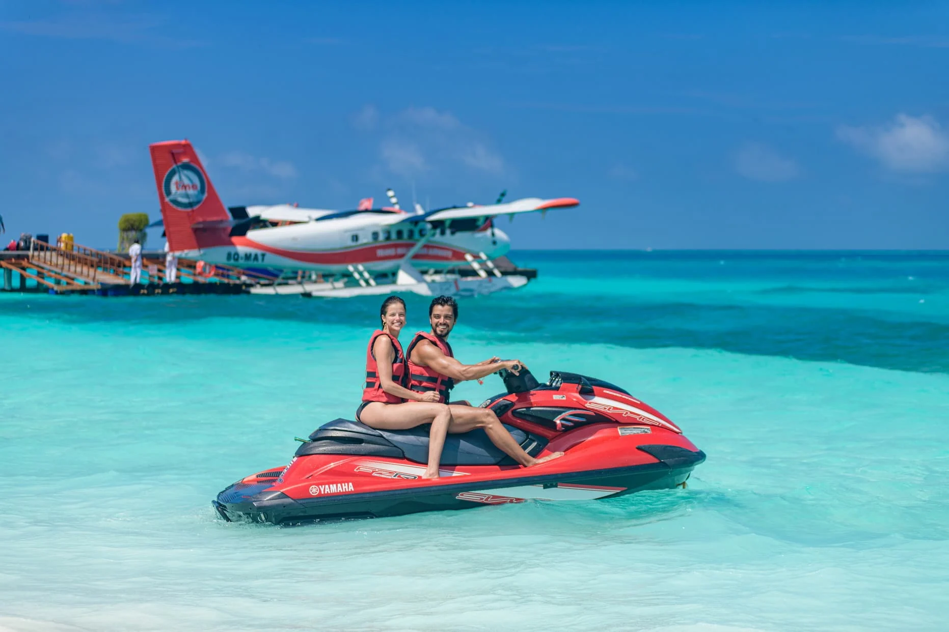 lux south ari atoll maldives couple jetski adventure riding across the lagoon