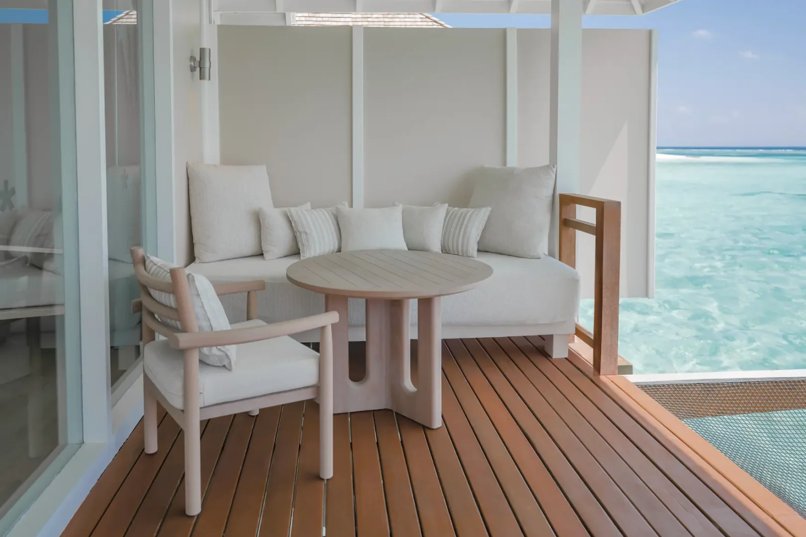 lux south ari atoll furnished terrace with relaxing open air seating and tropical views