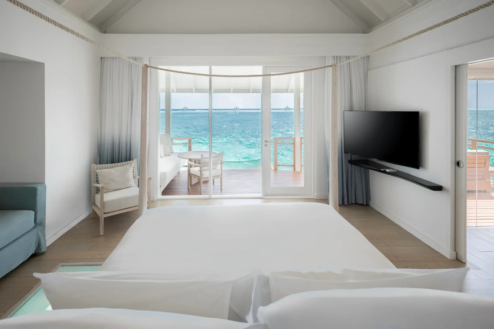 lux south ari atoll over water villas bedroom view overlooking the tranquil lagoon
