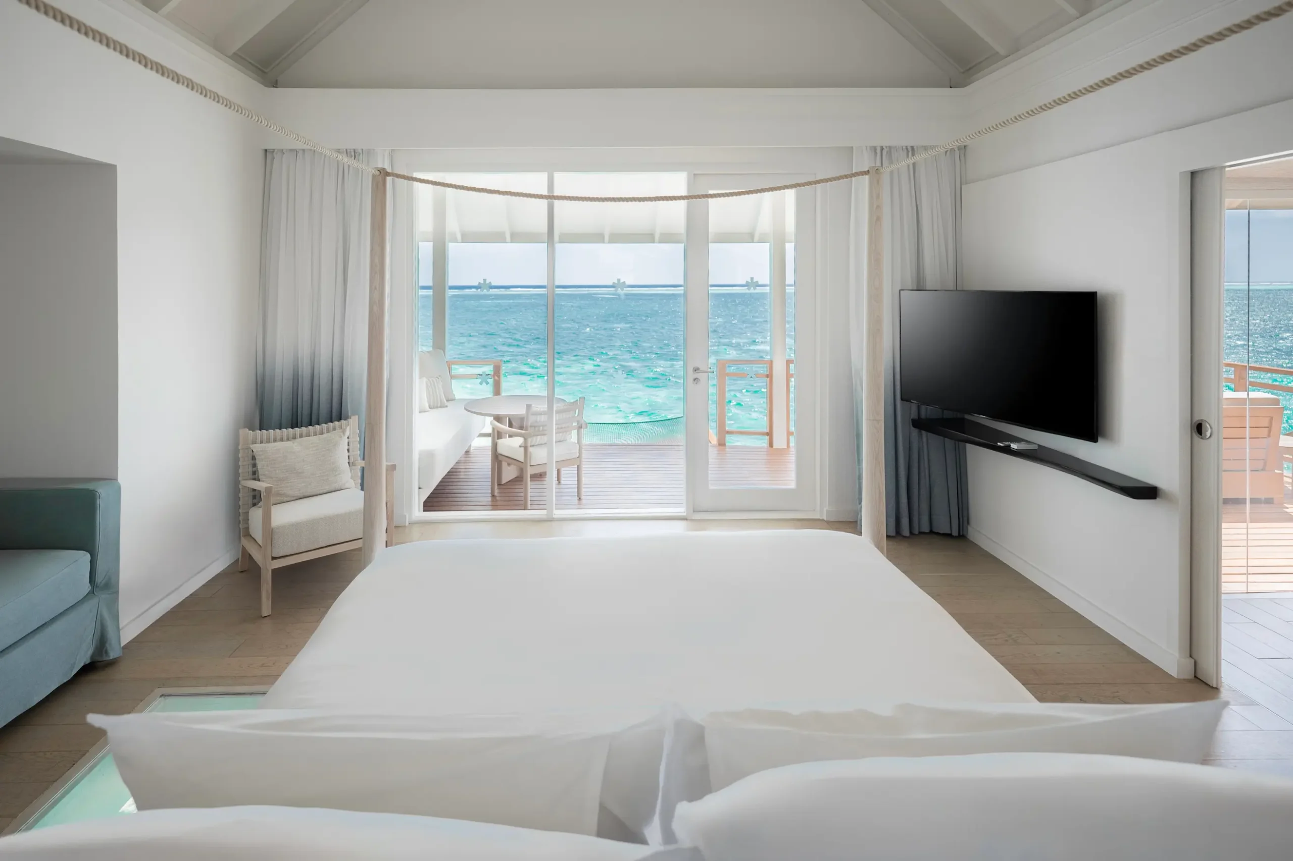 lux south ari atoll over water villas bedroom view overlooking the tranquil lagoon