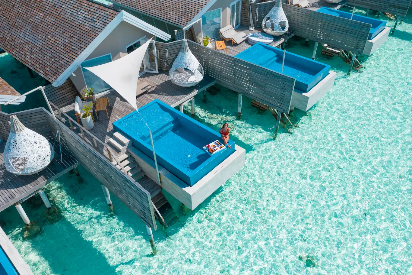 lux south ari atoll overwater infinity pool villa aerial view over the turquoise lagoon