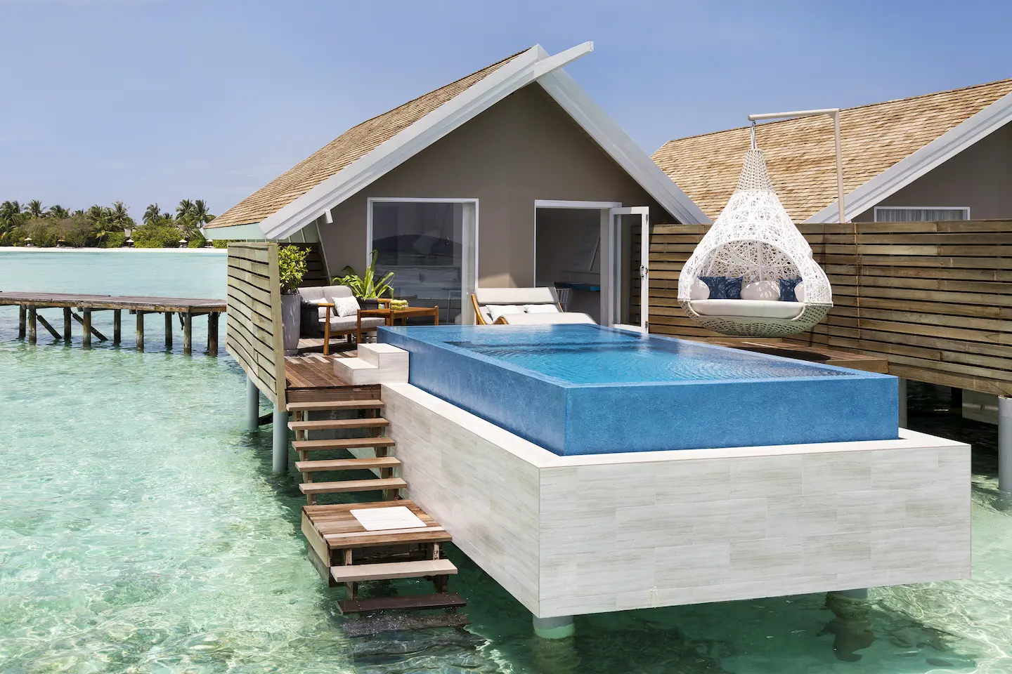 lux south ari atoll overwater infinity pool villa exterior view overlooking the tranquil lagoon