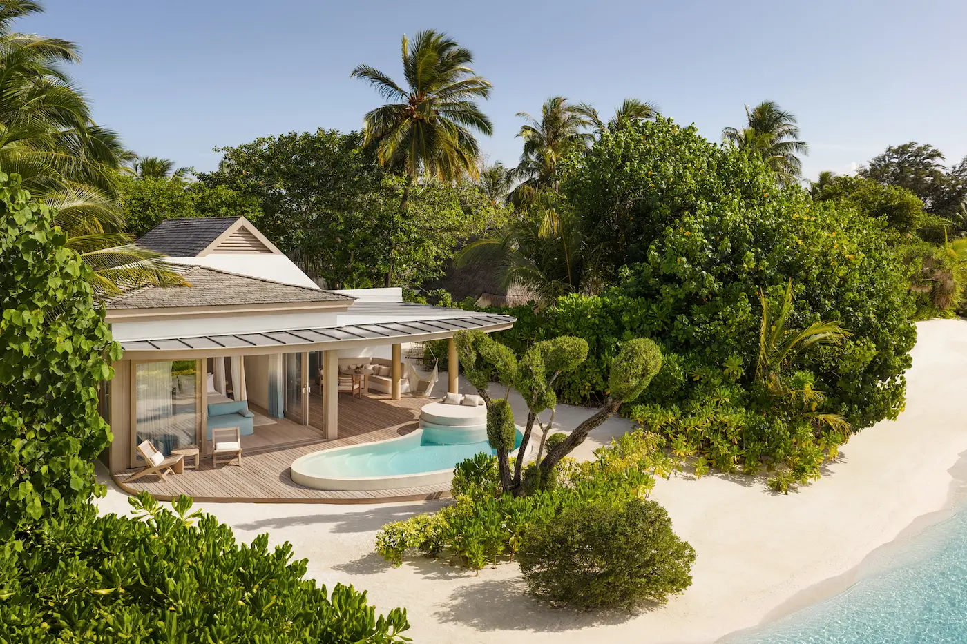 lux south ari atoll temptation beach pool villa exterior with serene beachfront surroundings