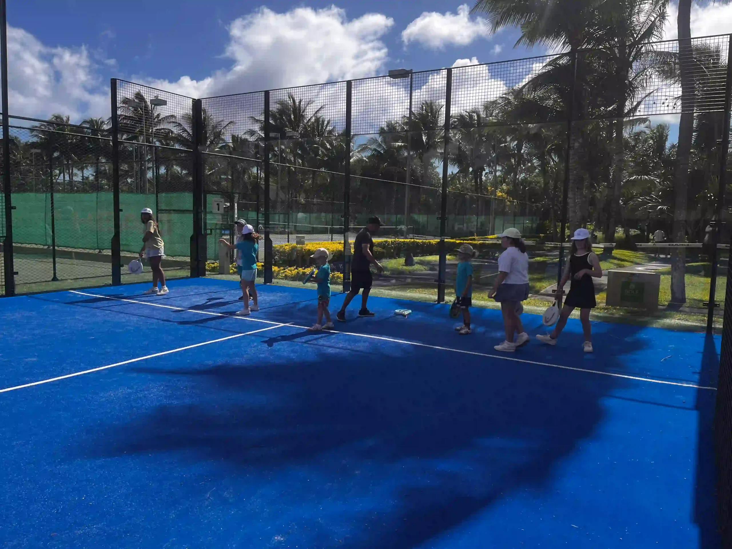 mauritius fam trip tennis with travelers playing on outdoor courts surrounded by tropical gardens and ocean views