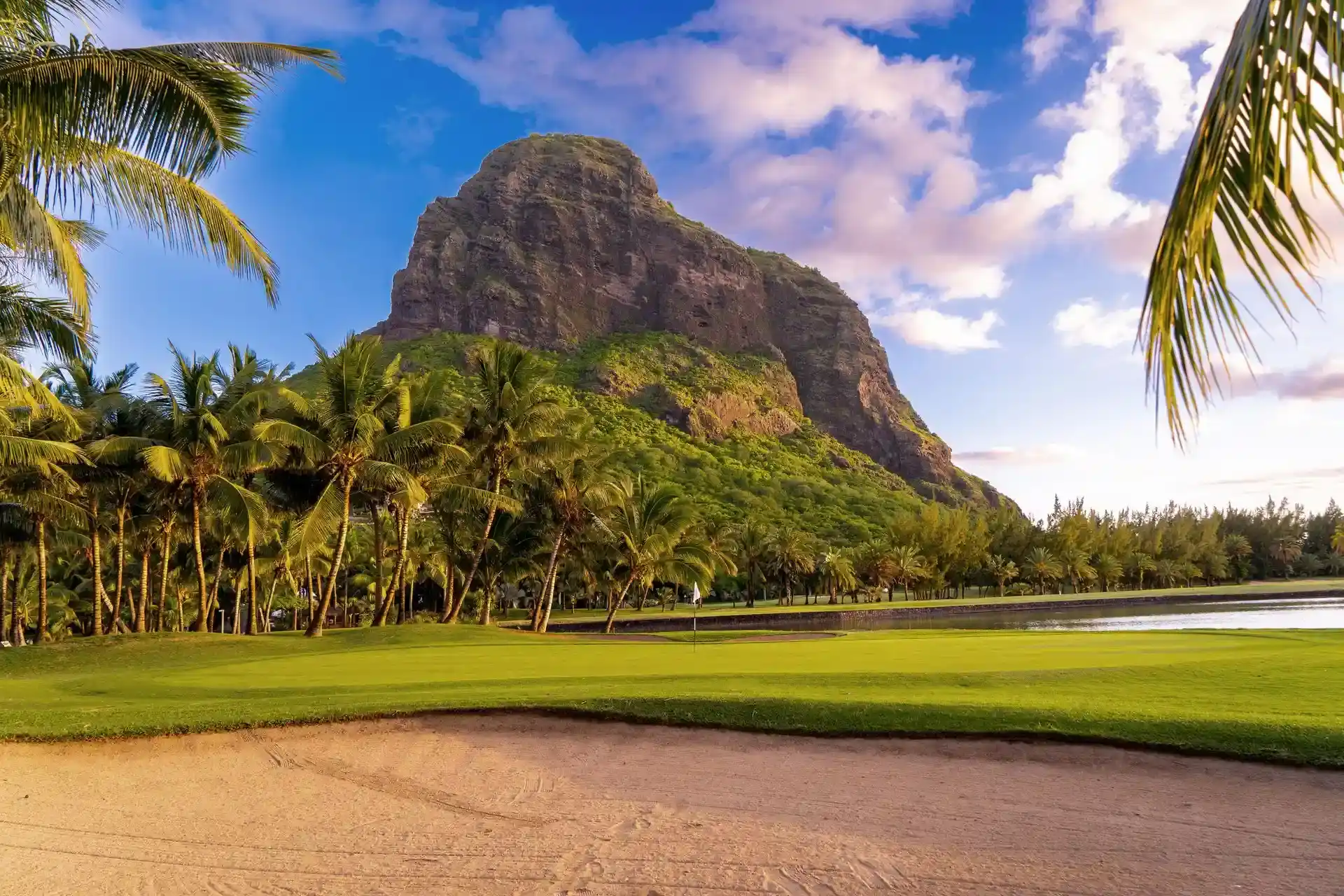 mauritius paradis golf course at sunset with ocean and mountain views