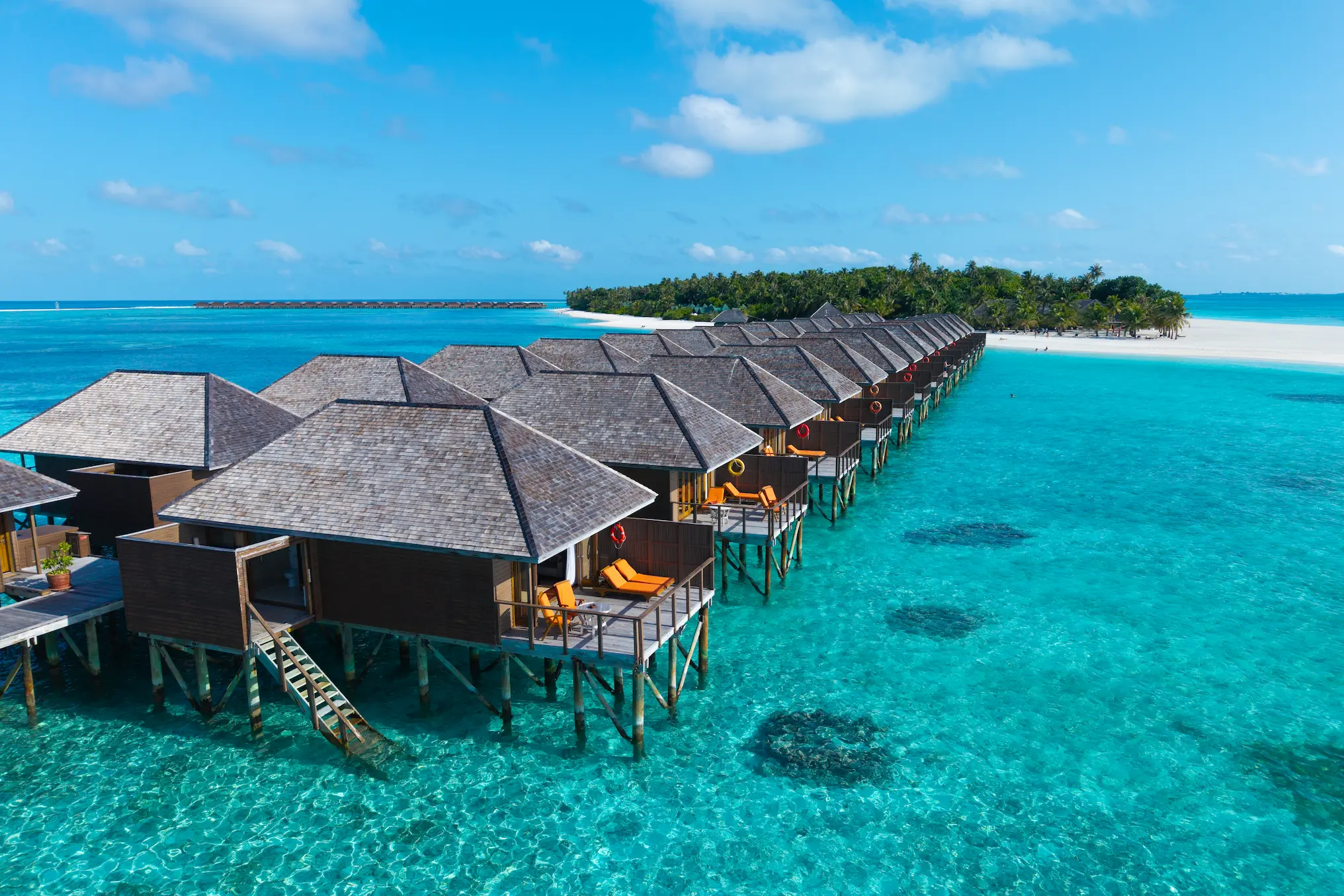 meeru maldives aerial water villa view with turquoise lagoon serene overwater setting and soft natural light creating a refined relaxed luxury island atmosphere