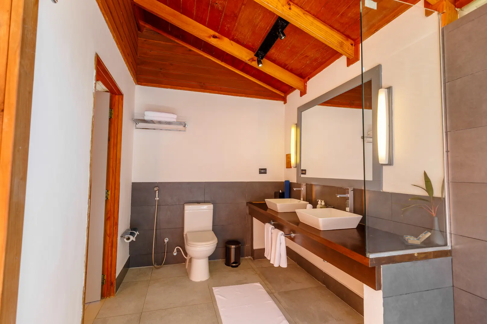 meeru maldives beach villa bathroom toilet area with soft natural light clean modern finishes and a refined serene atmosphere enhancing the resort’s relaxed luxury feel