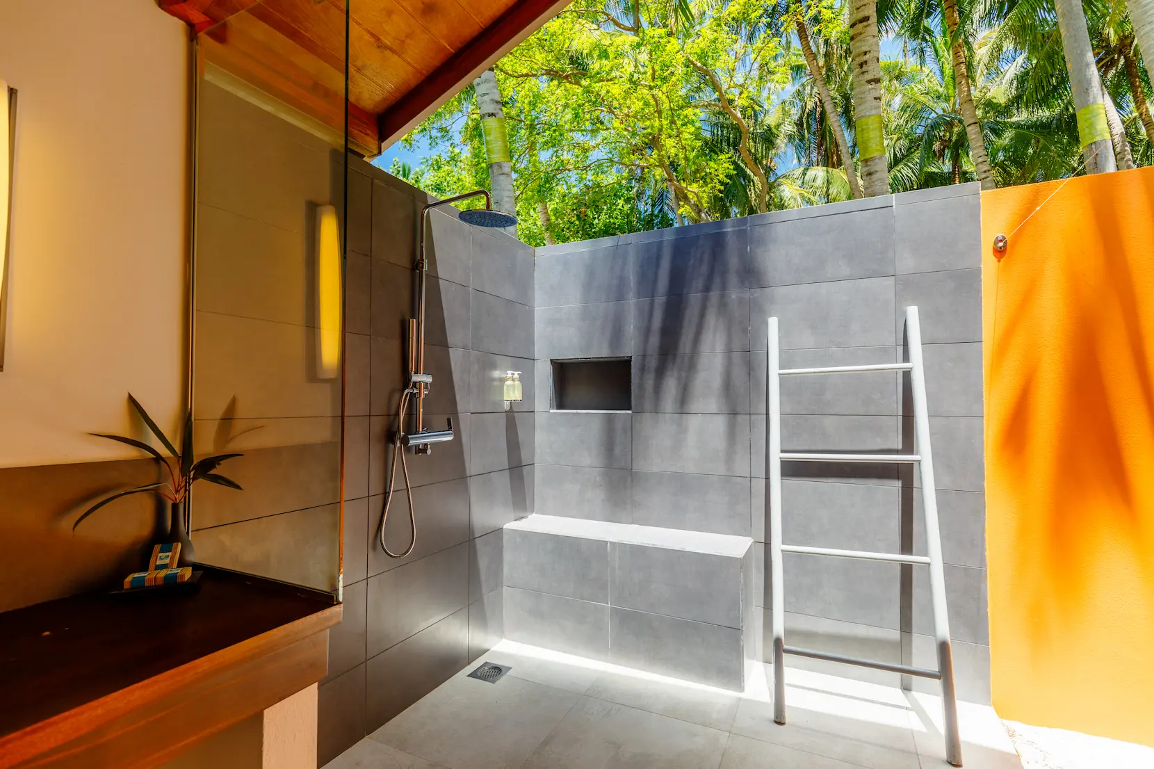 meeru maldives beach villa bathroom featuring soft natural lighting elegant stone finishes and a spacious serene layout that enhances the resort’s relaxed luxury atmosphere