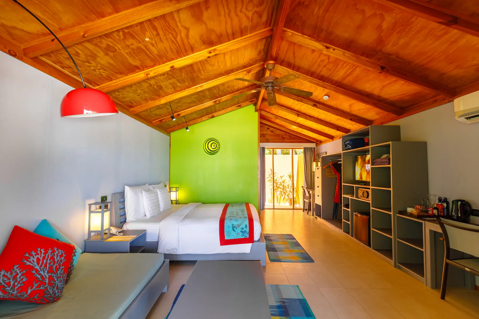 meeru maldives beach villa interior bed area with soft natural lighting warm wood accents and a refined serene atmosphere that highlights the resort’s relaxed luxury style