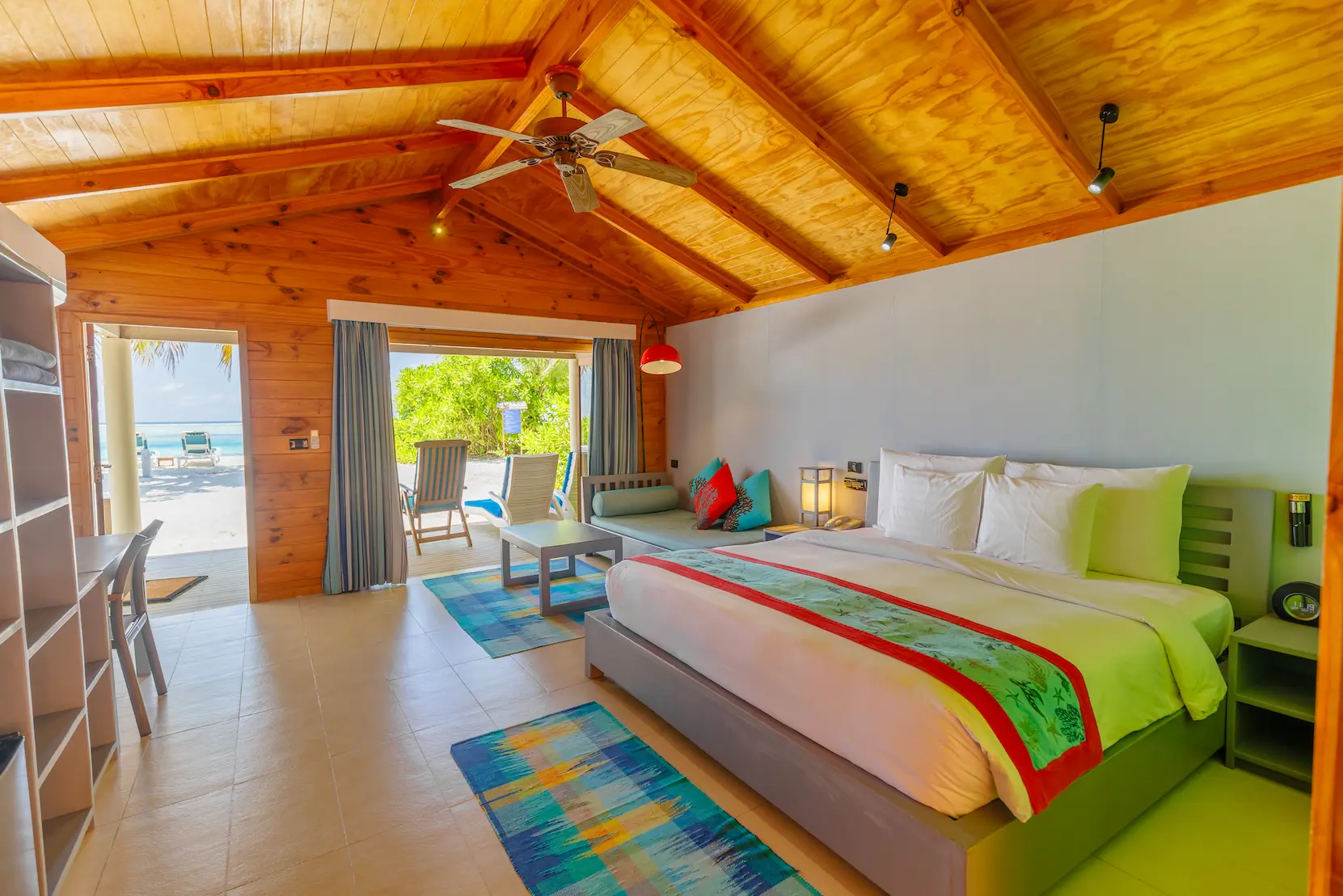 meeru maldives beach villa interior bedroom view with soft natural daylight warm wood textures and a serene elegant layout creating a calm luxurious resort atmosphere