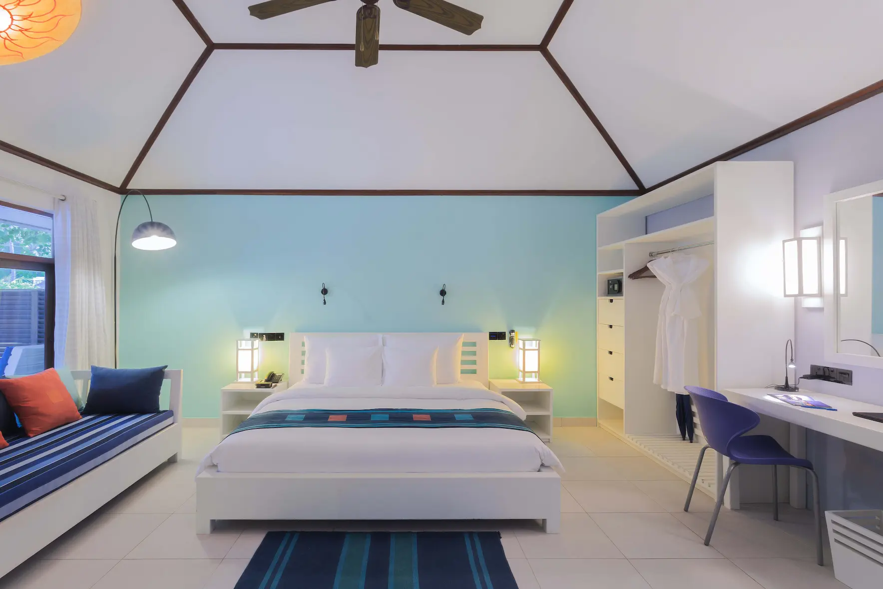 meeru maldives garden room interior bed area with soft natural light crisp linens warm wood textures and a calm contemporary layout creating a relaxed luxury resort atmosphere