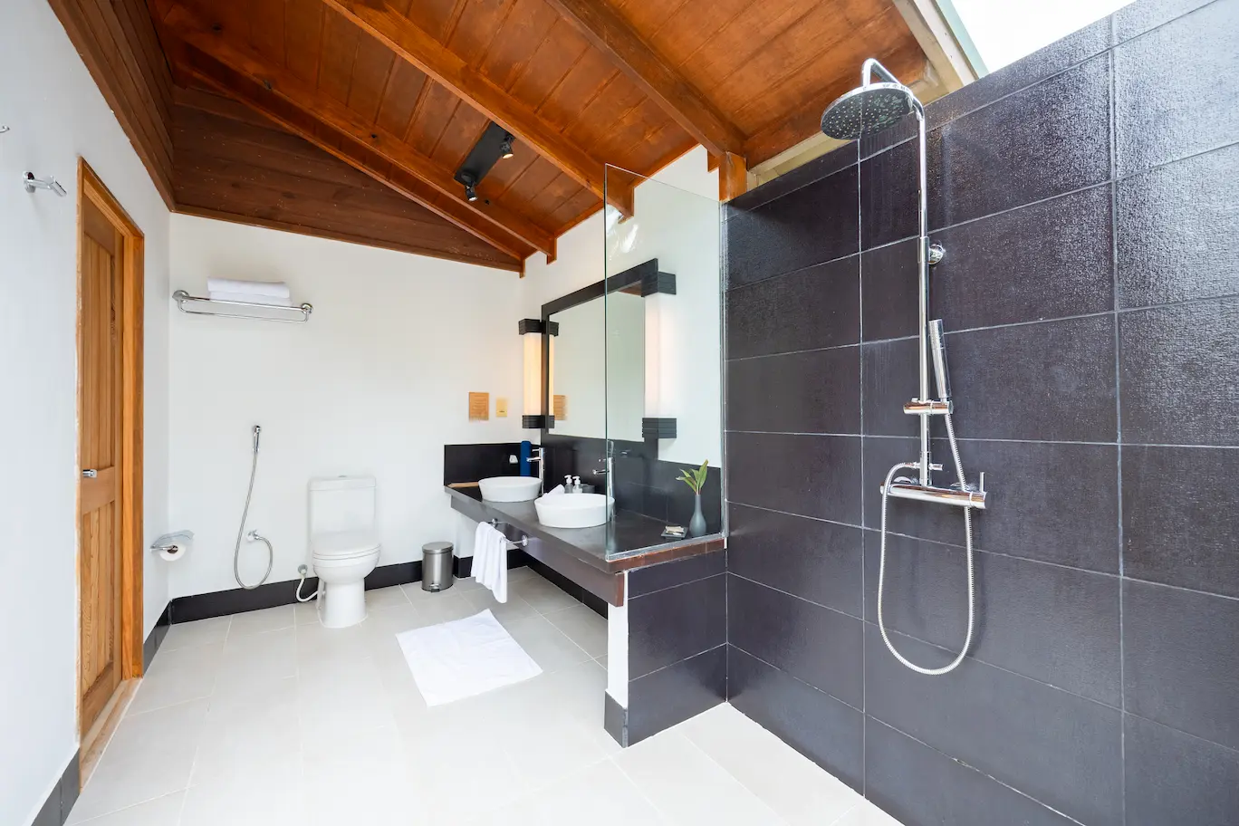 meeru maldives jacuzzi beach villa bathroom with soft natural lighting elegant stone finishes and a calm refined atmosphere that reflects the resort’s relaxed luxury style