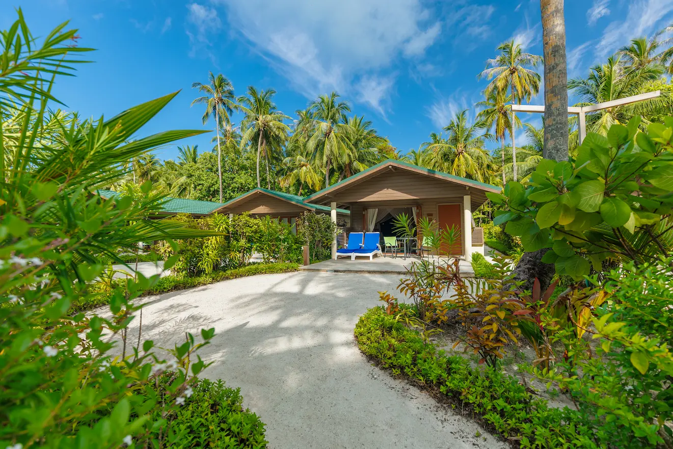 meeru maldives jacuzzi beach villa exterior with tropical greenery soft natural light and a calm refined beachfront atmosphere that reflects the resort’s relaxed luxury style
