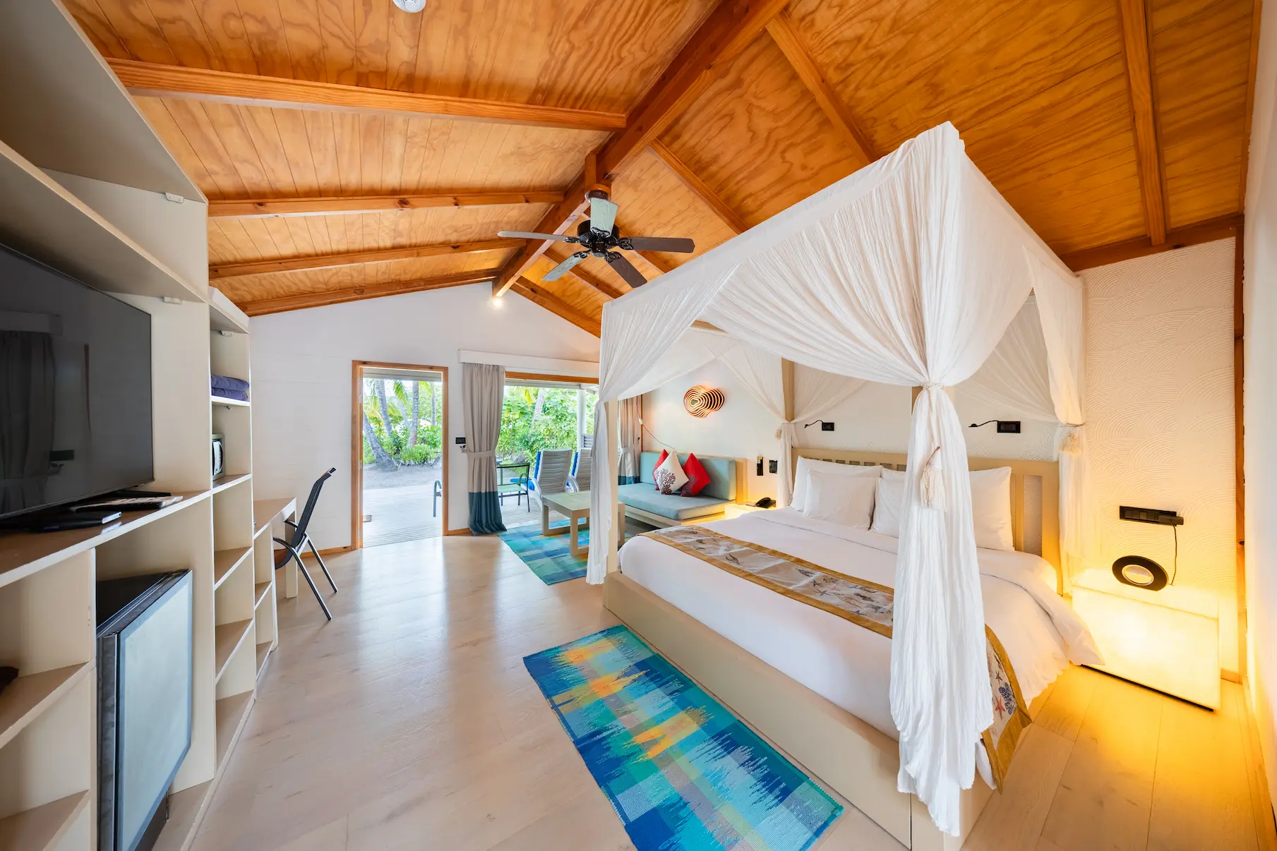 meeru maldives jacuzzi beach villa interior bed area with soft natural light warm wood textures and a calm refined atmosphere that enhances the resort’s relaxed luxury experience