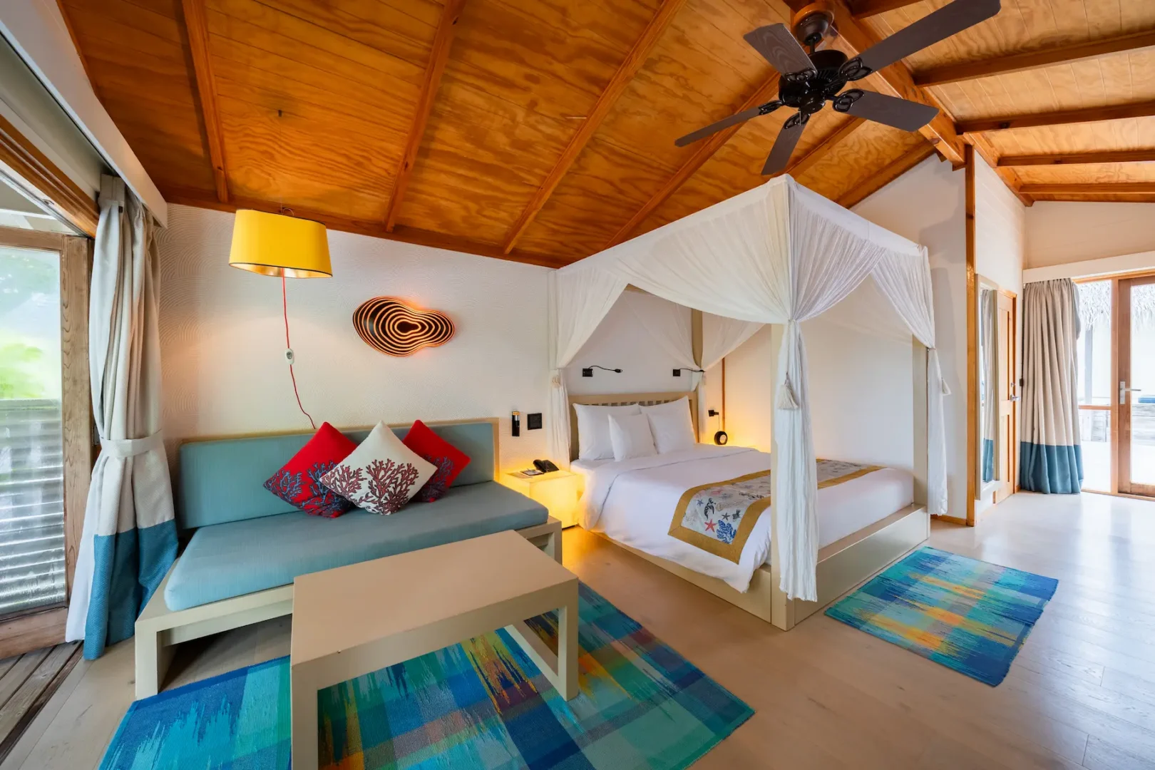 meeru maldives jacuzzi beach villa interior bedroom with soft natural lighting warm wood tones and a serene contemporary design that enhances the resort’s relaxed luxury atmosphere