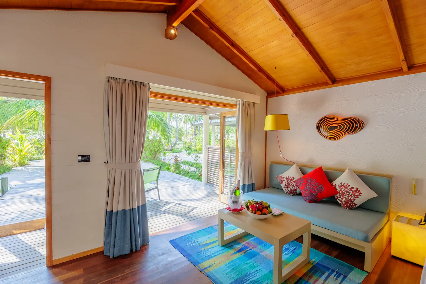 meeru maldives jacuzzi beach villa interior living area with warm natural light soft neutral textures and a refined contemporary layout creating a calm luxurious resort atmosphere