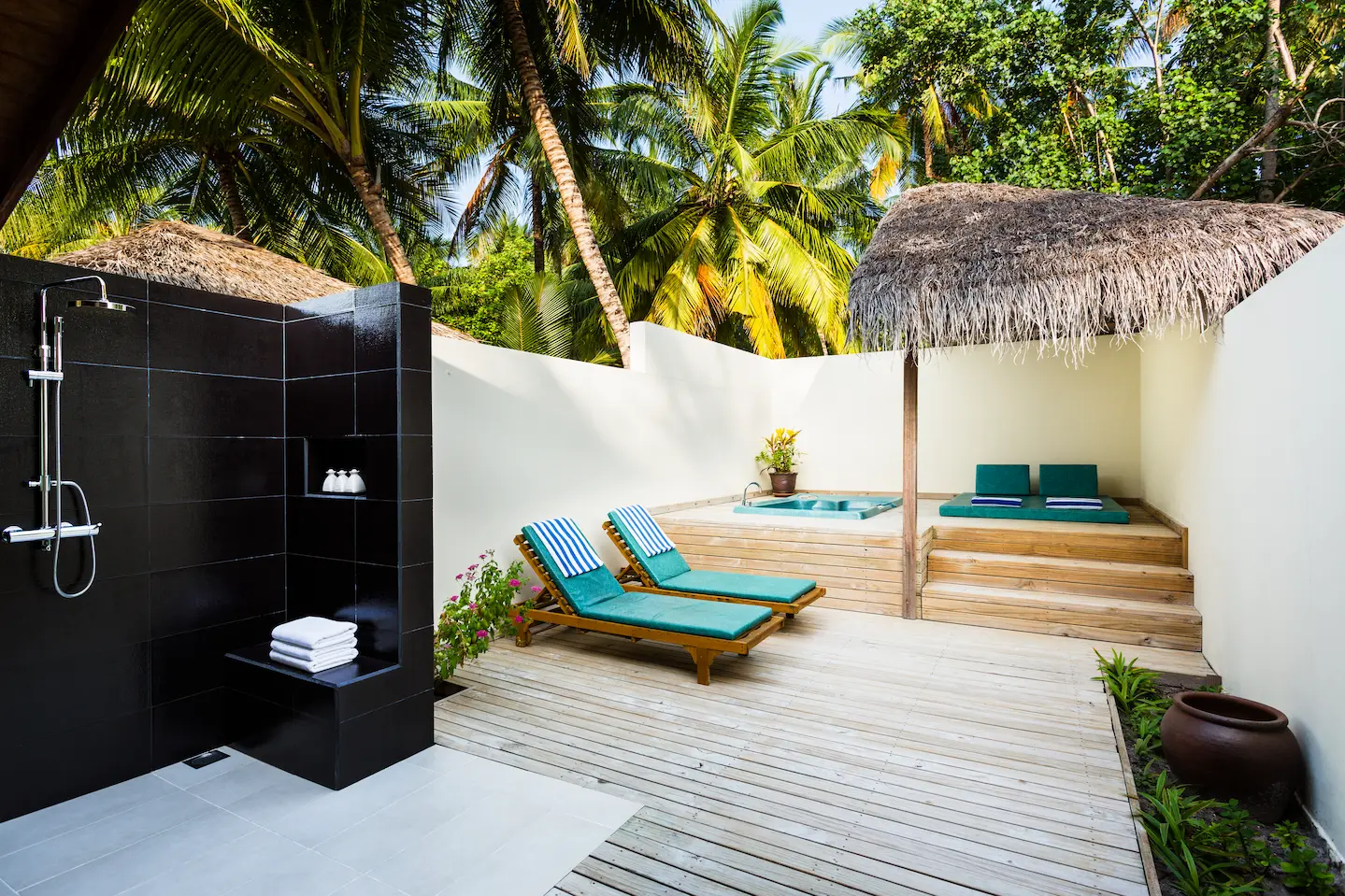 meeru maldives jacuzzi beach villa jacuzzi area with warm natural light tropical greenery and a serene private outdoor setting that enhances the resort’s relaxed luxury atmosphere