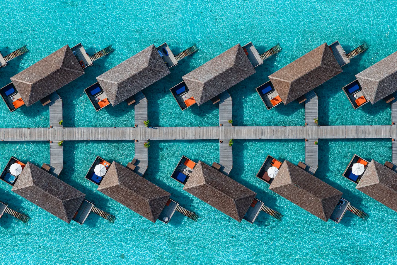 meeru maldives jacuzzi water villa aerial view showcasing the turquoise lagoon overwater villas and a serene tropical setting that reflects the resort’s relaxed luxury atmosphere